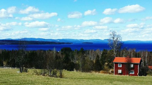 Scenic view of lake against cloudy sky