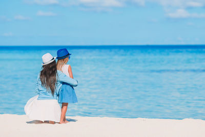 Rear view of women on beach