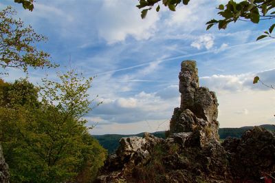 Low angle view of rock formation against sky
