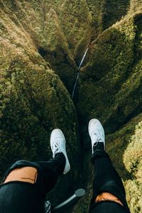 Low section of man hiking over rocks