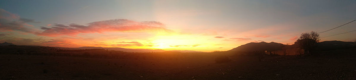 Scenic view of silhouette mountains against sky during sunset