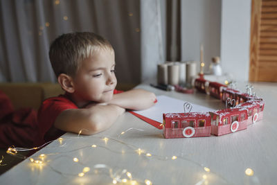 Close-up of boy playing with toy blocks at home