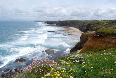 Scenic view of sea against cloudy sky