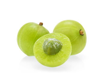 Close-up of green fruit against white background