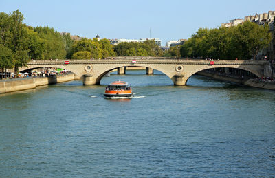 Tourist boat sailing on the seine river in paris i