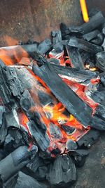 High angle view of fire on wood