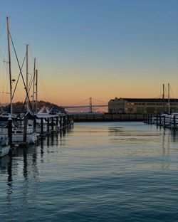 Sailboats on sea against clear sky during sunset