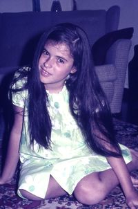 Portrait of young woman sitting outdoors