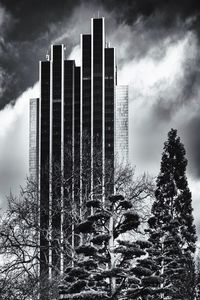 Skyscrapers against cloudy sky