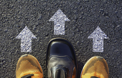 Low section of person standing on road