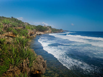 Scenic view of sea against blue sky