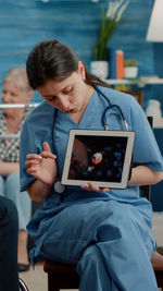 Young woman using laptop while sitting at home