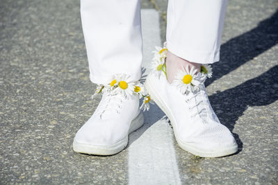 Low section of woman standing on street