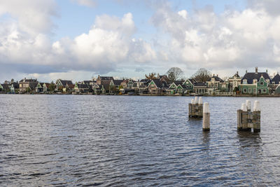 Buildings by sea against sky in city