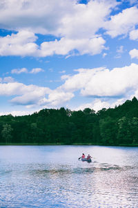 Scenic shot of calm lake against cloudy sky