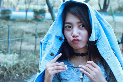 Young woman puckering while looking away on land