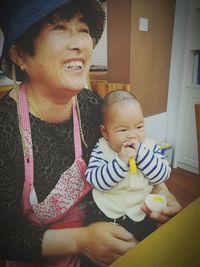 Portrait of happy mother with baby at home