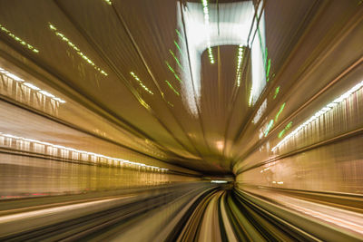 Blurred motion of illuminated subway station