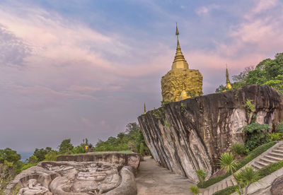 View of temple building against cloudy sky