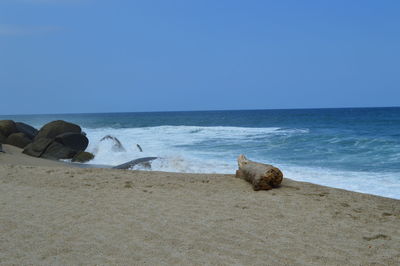 Scenic view of sea against clear blue sky