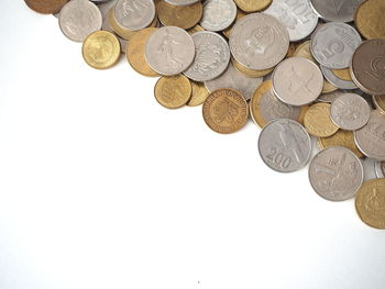 High angle view of coins on white background