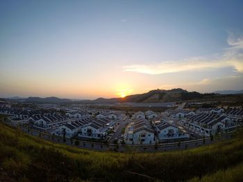 High angle view of buildings against sky during sunset
