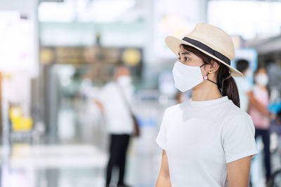 Beautiful woman with mask in airport