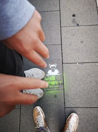 Low section of man standing on footpath