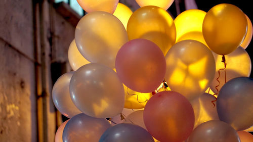 Group of pink helium balloon with backlit light at night