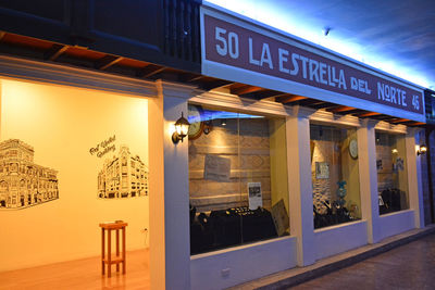 Information sign on illuminated restaurant at night