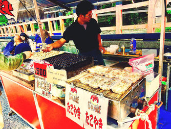 Full length of man for sale at market stall