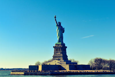 Statue of liberty against blue sky