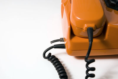 Close-up of telephone over white background