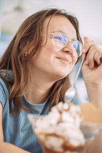 Portrait of young woman holding ice cream