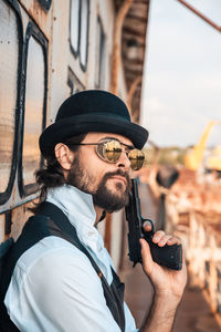 Portrait of man holding hat