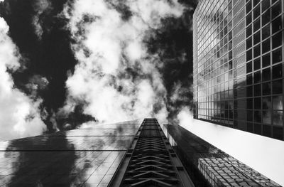 Low angle view of modern building against cloudy sky