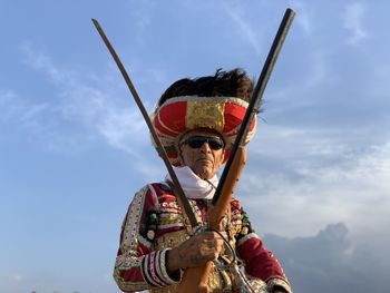 Low angle view of man standing against sky