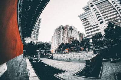 City street and buildings against sky