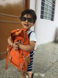 Portrait of smiling boy standing on floor