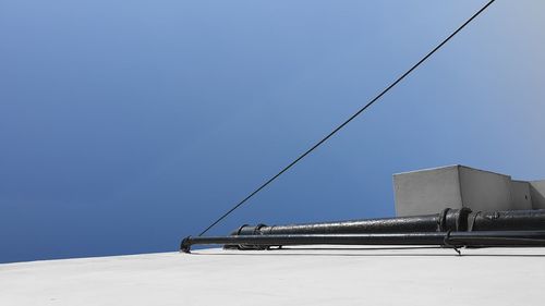 Cable car on street against clear blue sky