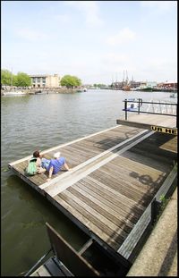 Boats in river with buildings in background