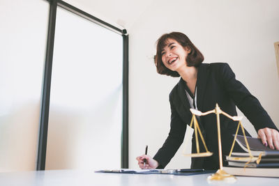 Smiling lawyer working at office