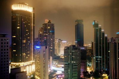 View of skyscrapers lit up at night