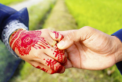 Close-up of couple holding hands