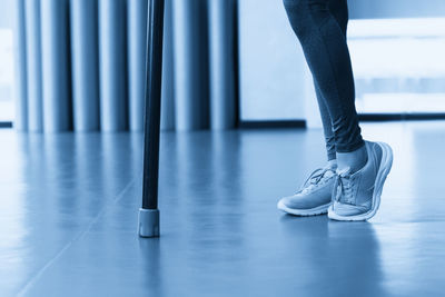 Low section of man walking on hardwood floor
