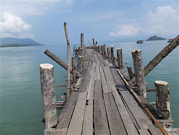 Wooden pier over sea against sky