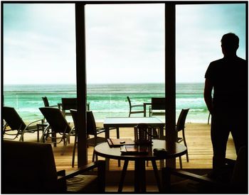 Empty chairs and tables at seaside