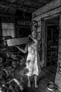 Low section of woman standing in abandoned house