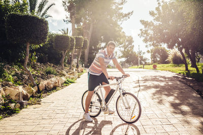 Woman riding bicycle on road