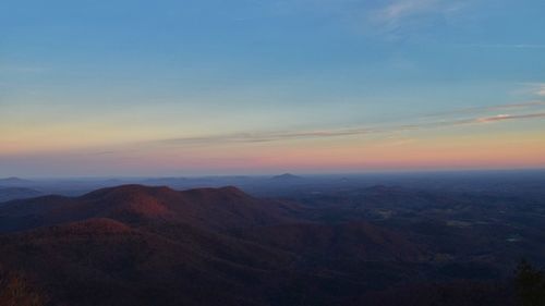 Scenic view of mountains against sky at sunset